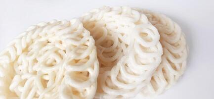 White noodle crackers or kerupuk putih or kerupuk warung made from tapioca flour, snack food from Indonesia isolated on white background photo