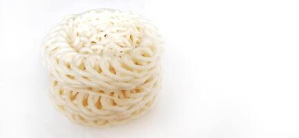 White noodle crackers or kerupuk putih or kerupuk warung made from tapioca flour, snack food from Indonesia isolated on white background photo