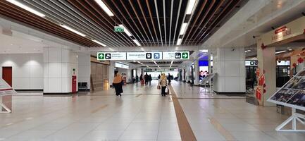 The atmosphere of KCIC Halim station, WHOOSH fast train, route Jakarta - Bandung. Modern passenger train moving fast on railway platform. Commercial transportation. Jakarta, Indonesia, October 28 2024 photo