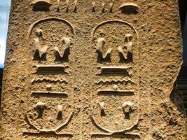 Old Egyptian hieroglyphs on an stone background. Ancient Egyptian hieroglyphs as pattern in Tombs. photo