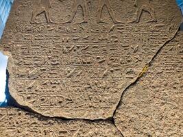 Old Egyptian hieroglyphs on an stone background. Ancient Egyptian hieroglyphs as pattern in Tombs. photo