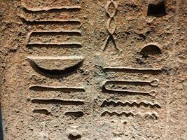 Old Egyptian hieroglyphs on an stone background. Ancient Egyptian hieroglyphs as pattern in Tombs. photo