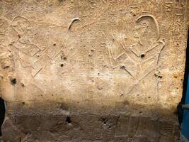 Old Egyptian hieroglyphs on an stone background. Ancient Egyptian hieroglyphs as pattern in Tombs. photo