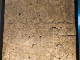 Old Egyptian hieroglyphs on an stone background. Ancient Egyptian hieroglyphs as pattern in Tombs. photo