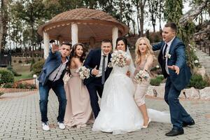 A group of people posing for a picture, including a bride and groom photo