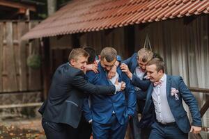 A group of men in suits are hugging each other photo