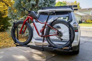 Fort Collins, CO, USA - October 25, 2024, Salsa Mukluk fat bike on the back of Toyota 4Runner SUV mounted with Kuat piston hitch rack. photo