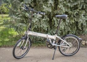 Fort Collins, CO, USA - May 4, 2023, A popular, lightweight, folding bike, Dahon Mariner D8, in a driveway ready for city commuting. photo