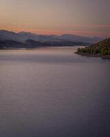 dusk over calm waters of Horsetooth Reservoir at foothills of Rocky Mountains in Colorado photo