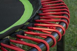 detail of mini trampoline for fitness exercising and rebounding in a backyard photo