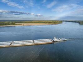towboat with barges on the Mississippi River at confluence with the Missouri River below Alton, IL photo