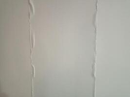 A white wall background with a crack in it photo