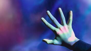 Mystical backdrop with outstretched hand illuminated by eerie lights photo