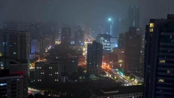 Shanghai's skyline at night features illuminated skyscrapers and dynamic light trails, with the iconic Shanghai Tower visible amidst a slight haze. video
