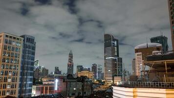 Shanghai's skyline at night features modern architecture and illuminated skyscrapers, including the Shanghai Tower, set against moving clouds. video