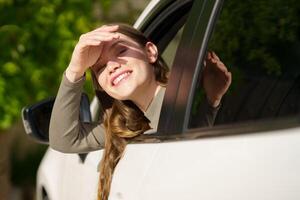 A Joyful Young Woman Happily Enjoying a Ride in a Car Under a Bright and Sunny Day photo