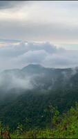 A view of the mountains and clouds from a hilltop video