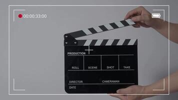 Close up hand holding empty film slate and clapping in front of camera video