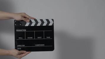 Close up hand holding empty film slate and clapping in front of camera video