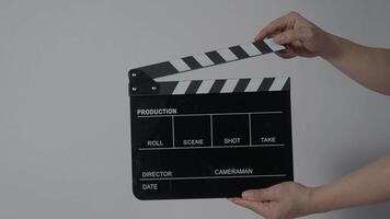 Close up hand holding empty film slate and clapping in front of camera video