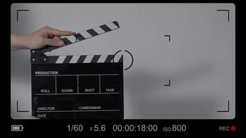 Close up hand holding empty film slate and clapping in front of camera video