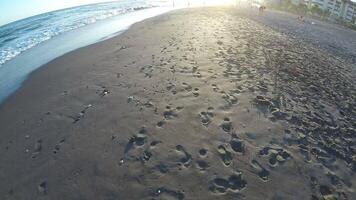 Walking in the beach at sunset, first person view, slow video