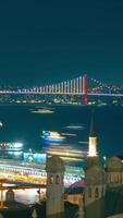 Visit Istanbul vertical background . Bosphorus Bridge and ships and ferries at night video