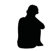 A silhouette of a child sitting on the floor vector