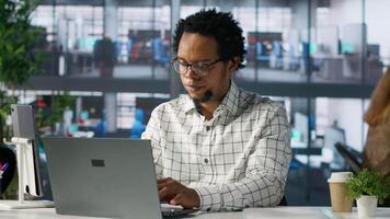 Skilled businessman at his office desk working on report writing, data analysis and deadline management. Male executive looking to expand the enterprise globally, multitasking at job. Camera A. video