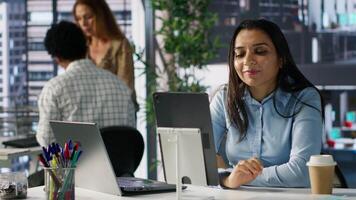 Professional indian worker leads a teleconference with team members, discussing project details and strategic objectives. Virtual meeting ensures efficient communication across locations. Camera A. video