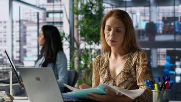 Business sales manager at work finalizes strategy planning in her office, doing report writing and answering emails. Worker collaborates on project management, uses data to drive decisions. Camera A. video