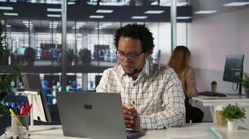 Black man general manager connects with his team via call, reviewing business operations and strategic objectives. Using online communication to enable efficient decision making. Camera B. video