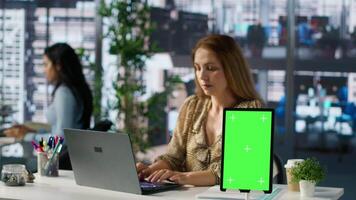 Female CEO engaging in project management using green screen to set goals and objectives, solve problems and track performance metrics of the company. Administrative tasks and decisions. Camera A. video