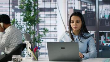 Executive assistant at multinational company work on next big business project. Indian worker uses data and tech tools to manage operations and ensure successful enterprise outcome. Camera A. video