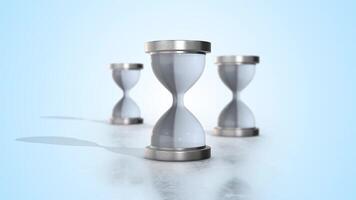 Hourglasses with Silver Color Frame on a Reflective Floor. Loading and Waiting. 4K video