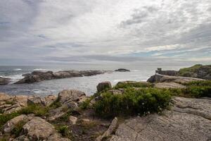 View from a cliff of the Atlantic Ocean on a cloudy day photo