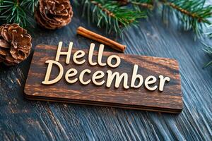Hello December sign with rustic wooden background and pine cones photo