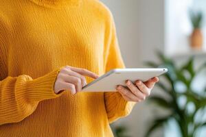 Engaged person using tablet in cozy indoor setting with plants photo