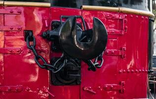 A coupler on an old locomotive that is well maintained and displayed at the station photo