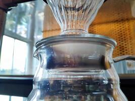 Set of pourover coffee server including heat resistant glass dripper mug, reusable filters or clever dripper, and wooden stand bracket holder, hand drip machine photo