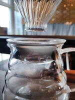 Set of pourover coffee server including heat resistant glass dripper mug, reusable filters or clever dripper, and wooden stand bracket holder, hand drip machine photo