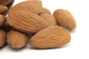 Closeup of raw almonds isolated on a white background photo