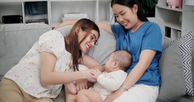 Portrait of Happy family having fun with little son on sofa in the living room. Enjoying fun time together, Multi-generation family photo