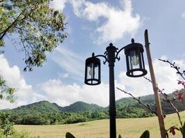 Lamppost with a view of rolling hills photo