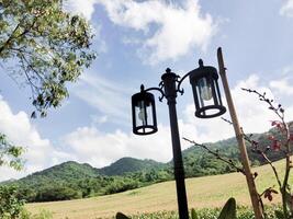 Lamppost against a backdrop of mountains and sky photo