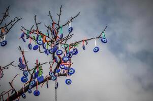 A tree with many evil eye ornaments hanging from it photo