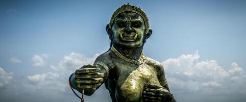 A statue of a man with his hands up in the air photo