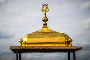 A golden dome with a cross on top photo