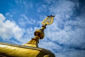 A golden cross on top of a building photo