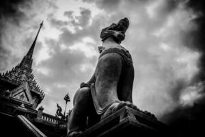 A statue of a dog in front of a temple photo